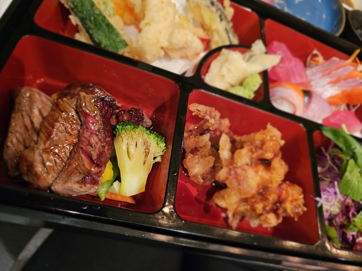 Fuga Tempura Bento with prawns, vegetables and grilled dishes in a red bento tray